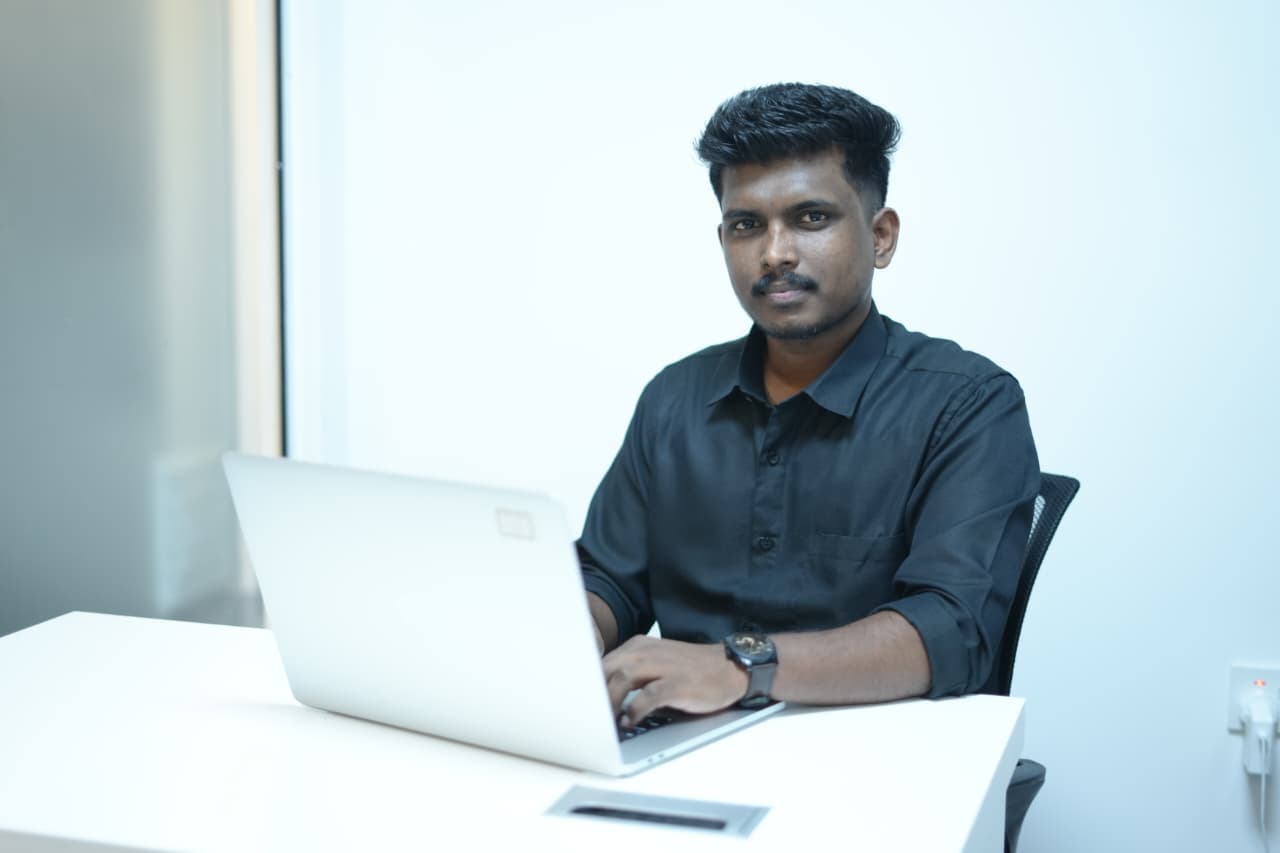 Ebson Joy working at his laptop